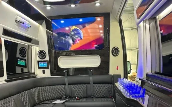 Luxurious van interior with leather seats and TV
