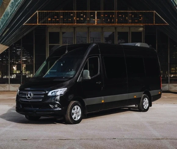 black cadillac xts luxury sedan parked near building