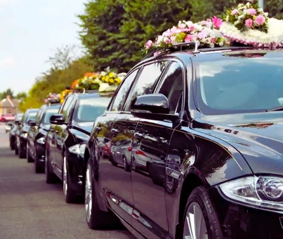 Funeral procession with black luxury vehicles for memorial transportation in Columbus